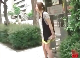 Squirming and trying her best to do it publicly